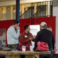 Four alumni socializing at the Fowling Fun Event